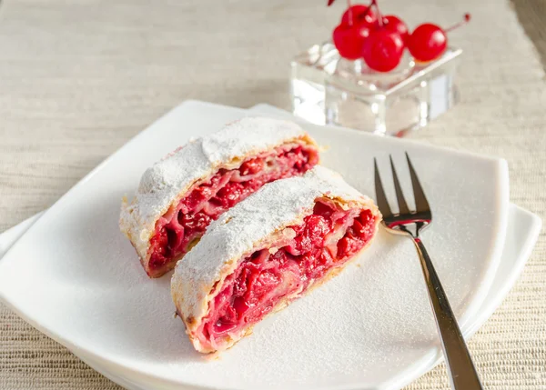 Cherry strudel on the square plate — Stock Photo, Image