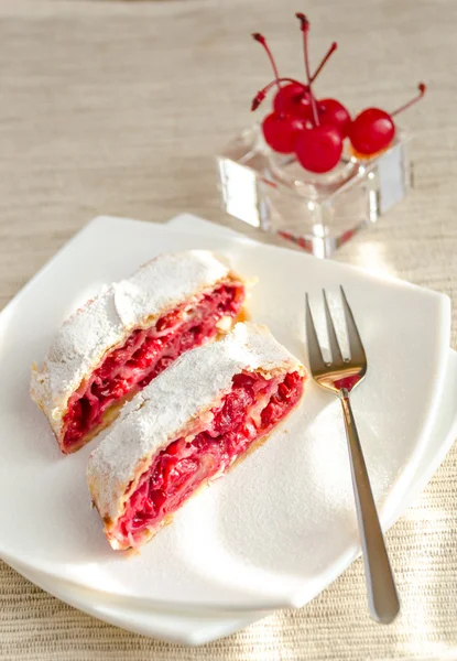 Cherry strudel on the square plate — Stock Photo, Image