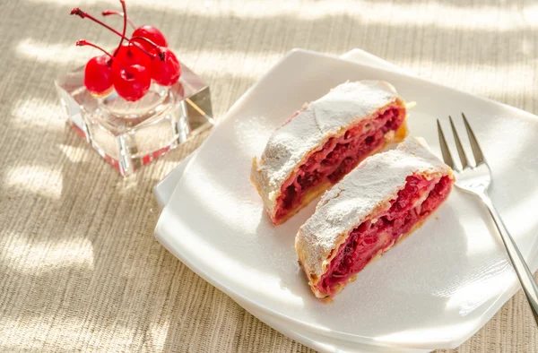 Cherry strudel on the square plate — Stock Photo, Image