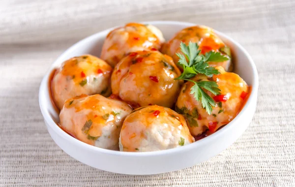 Chicken meatballs with parmesan under spicy sauce — Stock Photo, Image