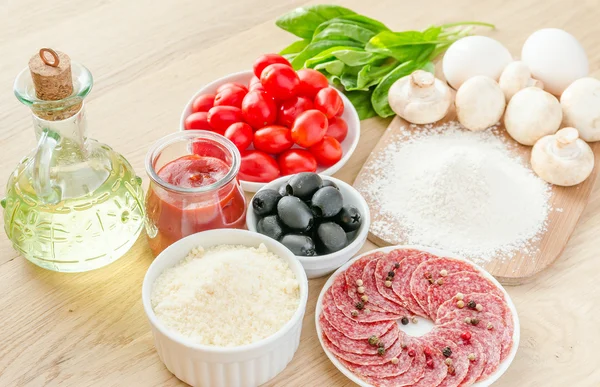 Ingredients for pizza on the wooden background — Stock Photo, Image