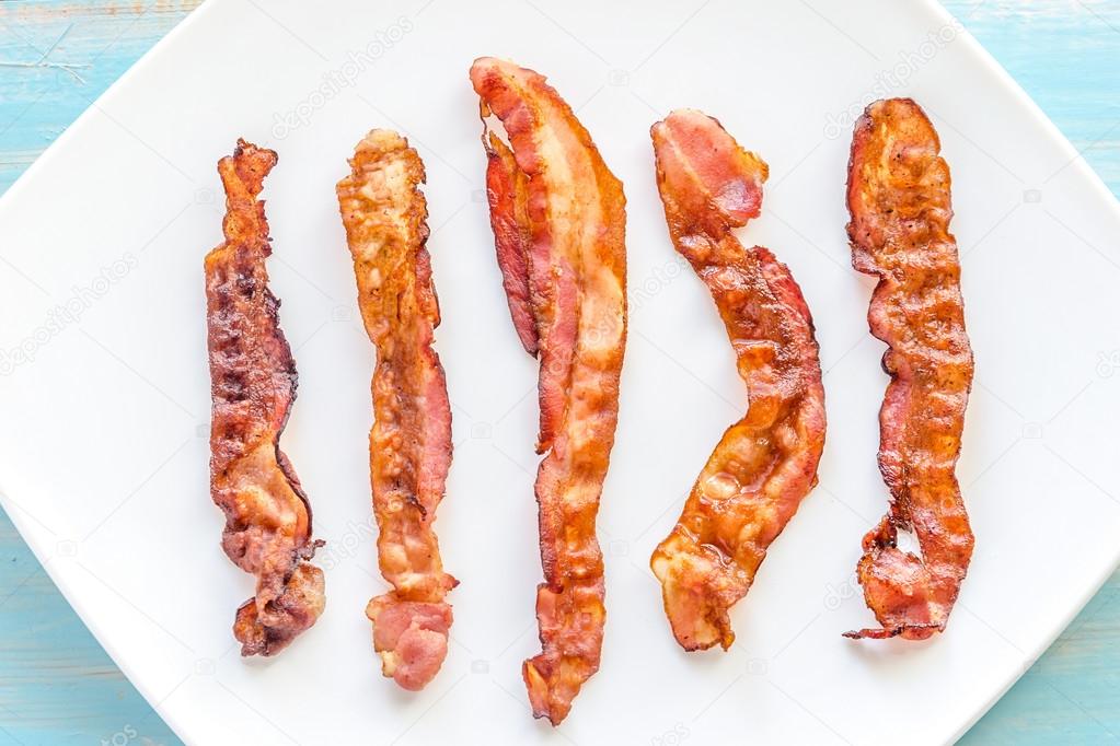 Fried bacon strips on the square plate