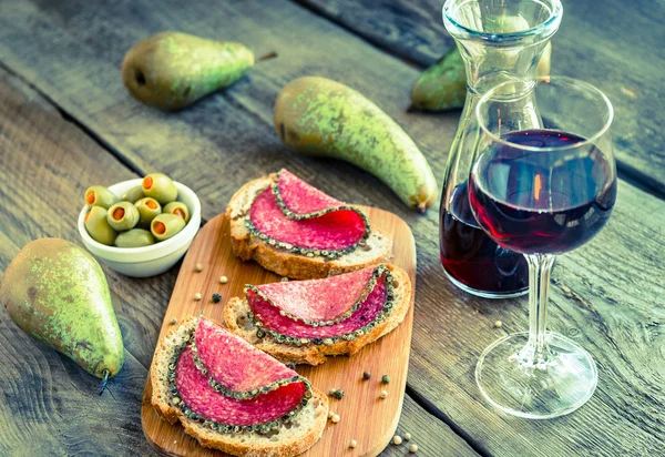 Scheiben italienische Salami mit Birnen und Wein — Stockfoto