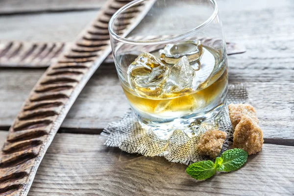 Glass of rum on the wooden background — Stock Photo, Image