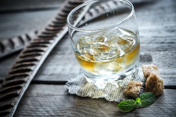 Glass of rum on the wooden background — Stock Photo, Image