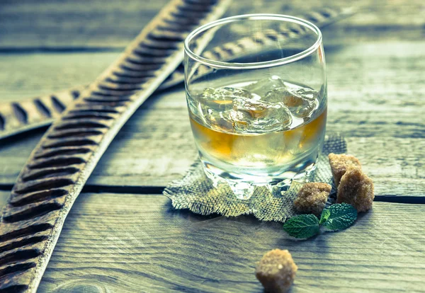 Glass of rum on the wooden background — Stock Photo, Image