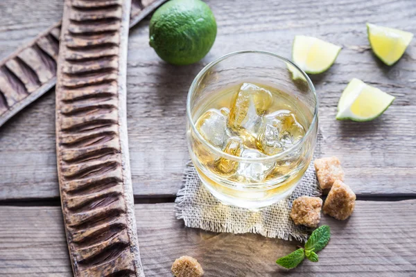 Glass of rum on the wooden background — Stock Photo, Image