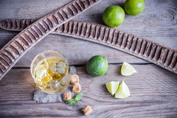 Glass of rum on the wooden background — Stock Photo, Image