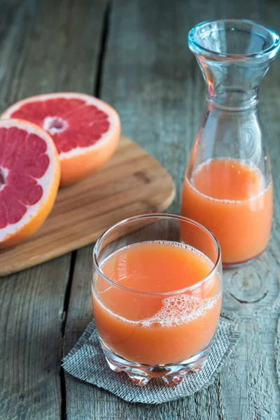 Grapefruit juice on the wooden table — Stock Photo, Image