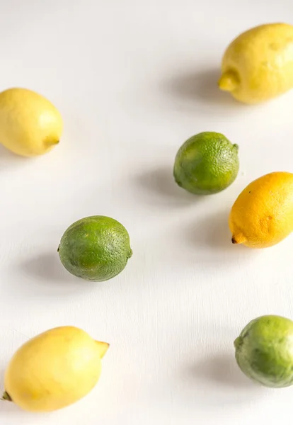 Lemons and limes on the white background — Stock Photo, Image