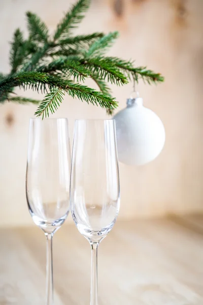 Christmas tree branch with empty champagne glasses — Stock Photo, Image
