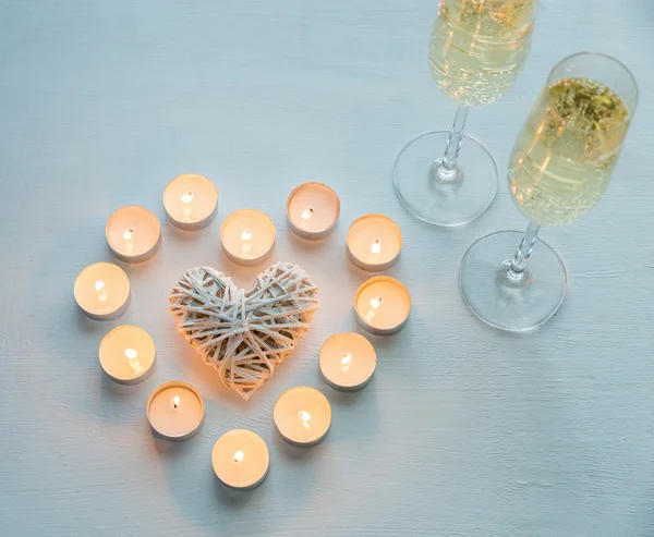 Two glasses of champagne with candles — Stock Photo, Image