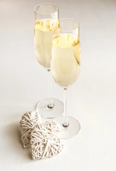 Two glasses of champagne with hearts — Stock Photo, Image