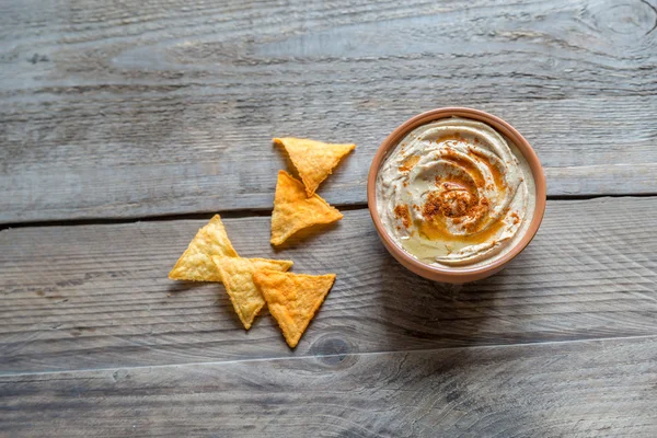 Un tazón de hummus con chips de maíz — Foto de Stock