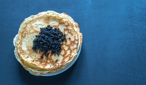 Pile of crepes with black caviar — Stock Photo, Image