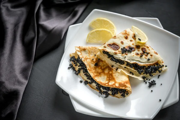 Crepes with black caviar — Stock Photo, Image