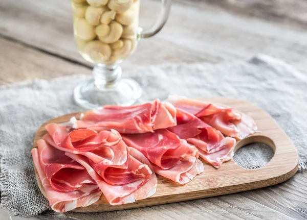 Slices of jamon on the wooden board — Stock Photo, Image