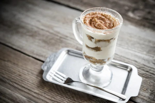 Tiramisu in the glass on the wooden background — Stock Photo, Image