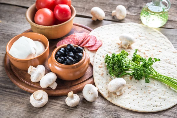 Ingredients for pizza on the wooden background — Stock Photo, Image