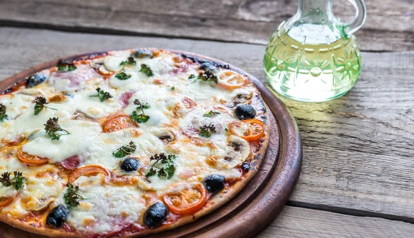 Cooked pizza on the wooden board — Stock Photo, Image