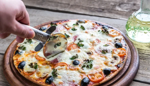 Cooked pizza on the wooden board — Stock Photo, Image