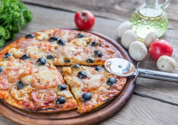 Cooked pizza on the wooden board — Stock Photo, Image