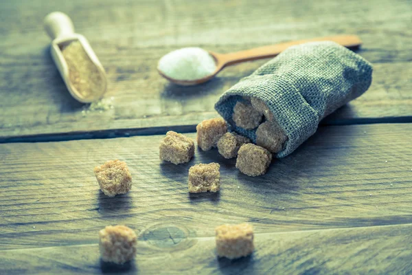 Brown and white sugar on the wooden background — Stock Photo, Image