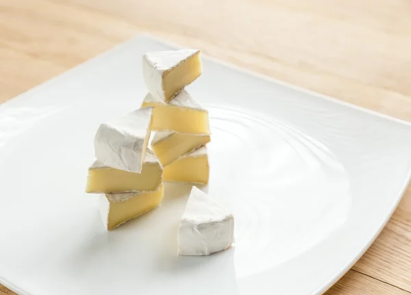 Slices of Camembert on the plate — Stock Photo, Image