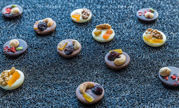 Swiss chocolate candies with nuts and dried fruits — Stock Photo, Image
