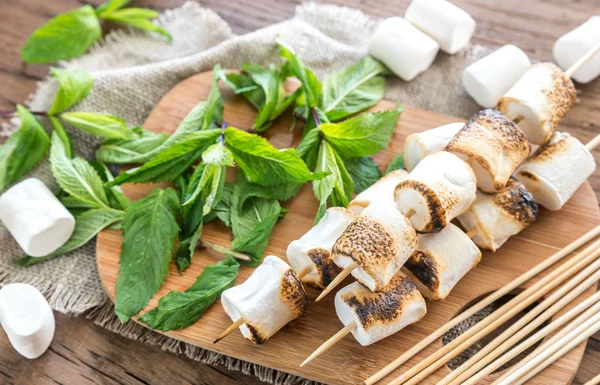 Marshmallow skewers on the wooden board — Stock Photo, Image