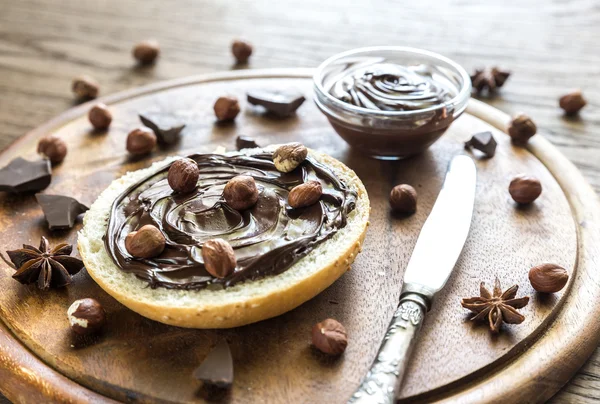 Sesame bun with chocolate cream and nuts — Stock Photo, Image