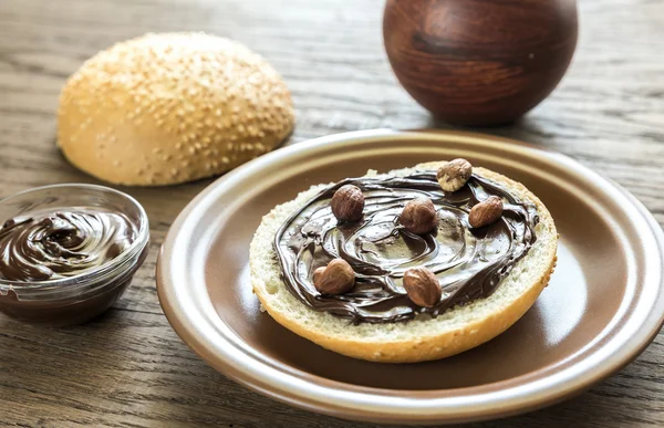 Sesame bun with chocolate cream and nuts — Stock Photo, Image