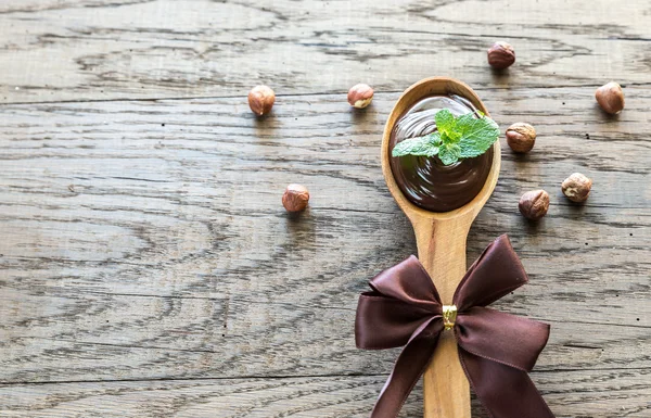 Colher de madeira de creme de chocolate com hortelã fresca — Fotografia de Stock