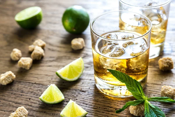 Glass of rum on the wooden background — Stock Photo, Image