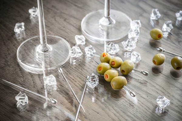 Two martini glasses with olives on martini picks — Stock Photo, Image