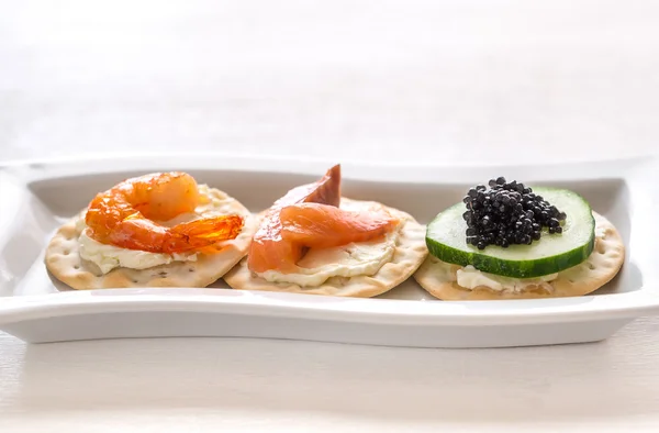 Canape with seafood on the plate — Stock Photo, Image