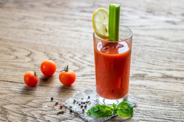 Bloody Mary cocktail on the wooden background clipart