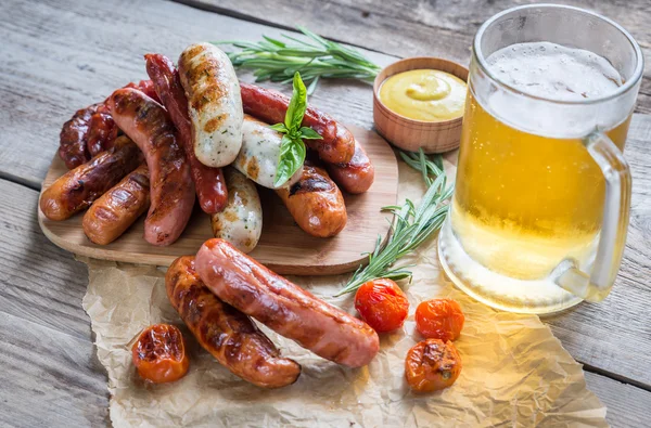 Grilled sausages with glass of beer — Stock Photo, Image