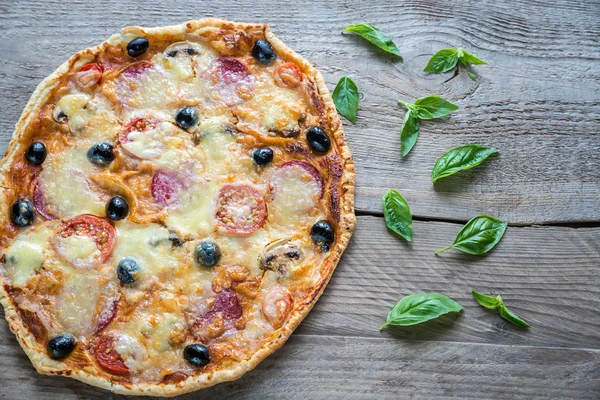 Pizza on the wooden board — Stock Photo, Image