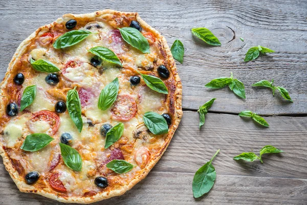 Pizza on the wooden board — Stock Photo, Image