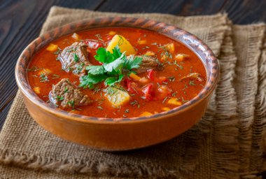 Warm, aromatic stew served in rustic pottery evokes countryside comfort and rich culinary heritage