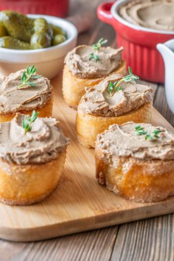 Herb-garnished pate pairs elegantly with sweet cranberry and crisp cornichons for refined flavor balance