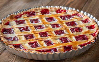 Golden crust gleams under soft light, revealing sweet cherry filling and comforting homemade aroma