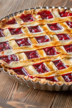Golden crust gleams under soft light, revealing sweet cherry filling and comforting homemade aroma