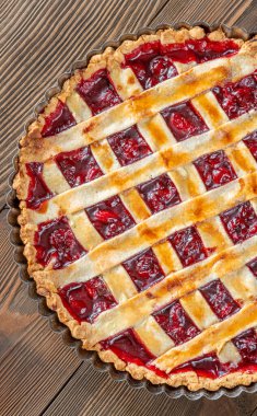 Golden crust gleams under soft light, revealing sweet cherry filling and comforting homemade aroma