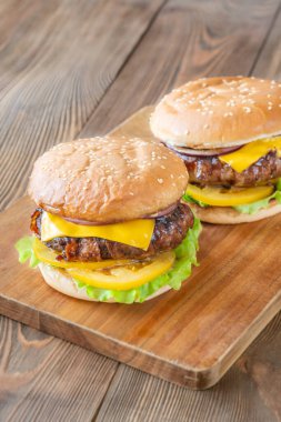 Melted cheese and crisp bacon meet golden buns in a hearty rustic presentation