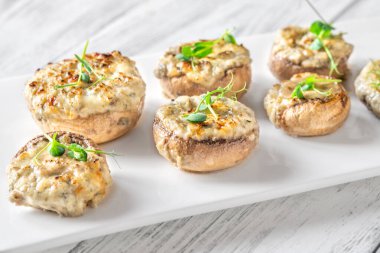 Toprak mantarlar beşikte kremalı sarımsak dolarken sıcak dokular zengin rahatlatıcı lezzeti ön plana çıkarıyor.