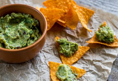 Guacamole with tortilla chips clipart