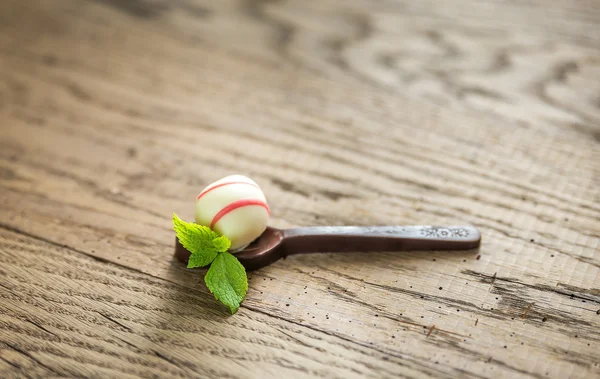 White chocolate candy in the dark chocolate spoon — Stock Photo, Image