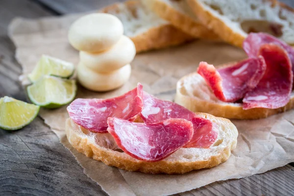 Ciabatta sandwiches with fuet and mini cheese — Stock Photo, Image